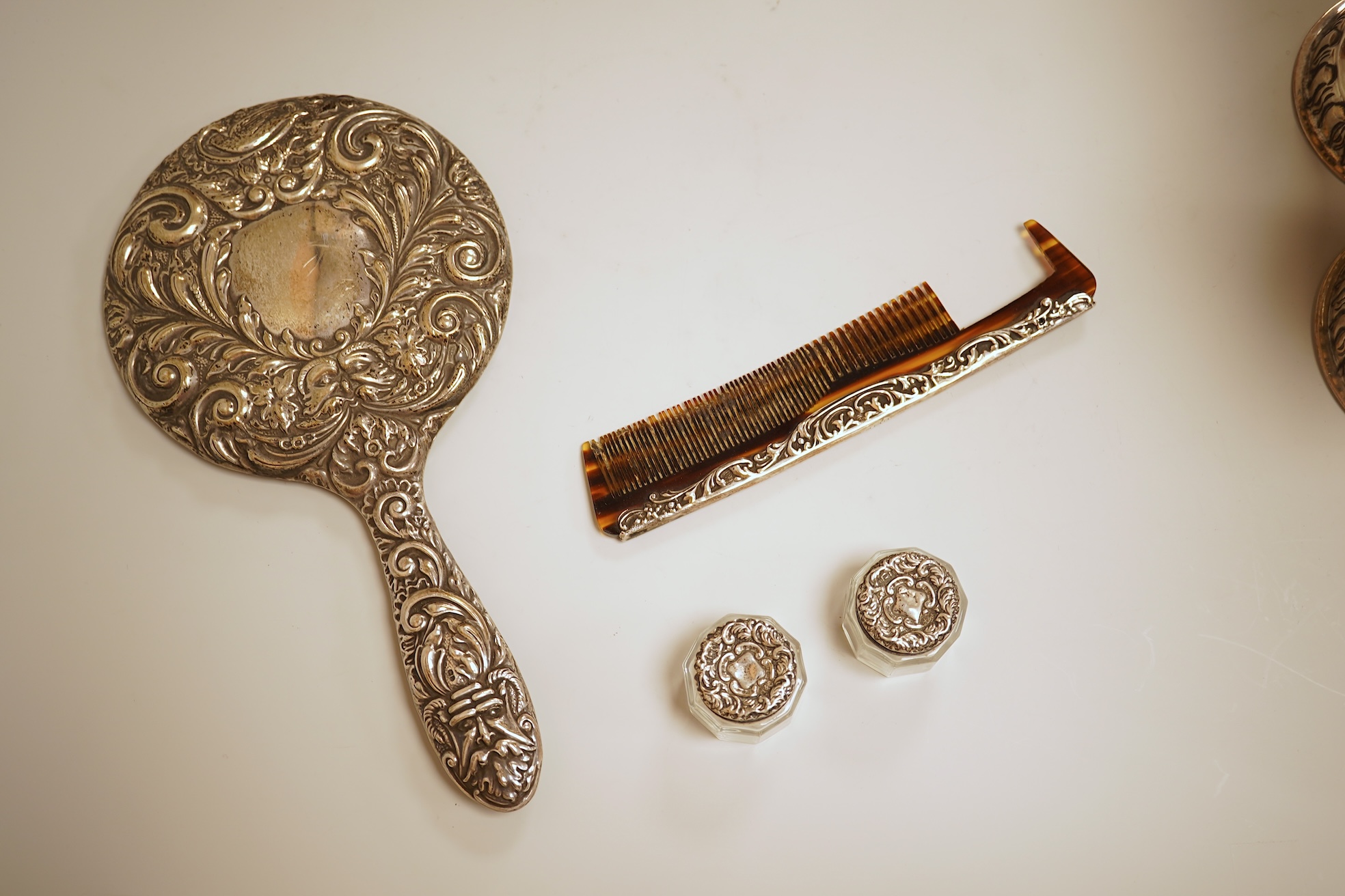 A pierced 800 standard white metal fruit bowl, diameter 23.6cm, a silver mounted hand mirror and two brushes, a 19th century continental white metal pyx, a pair of George V silver mounted whisky noggins, Birmingham, 1925